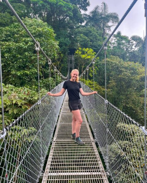 a girl on a hangingb bridge in costa rica nature