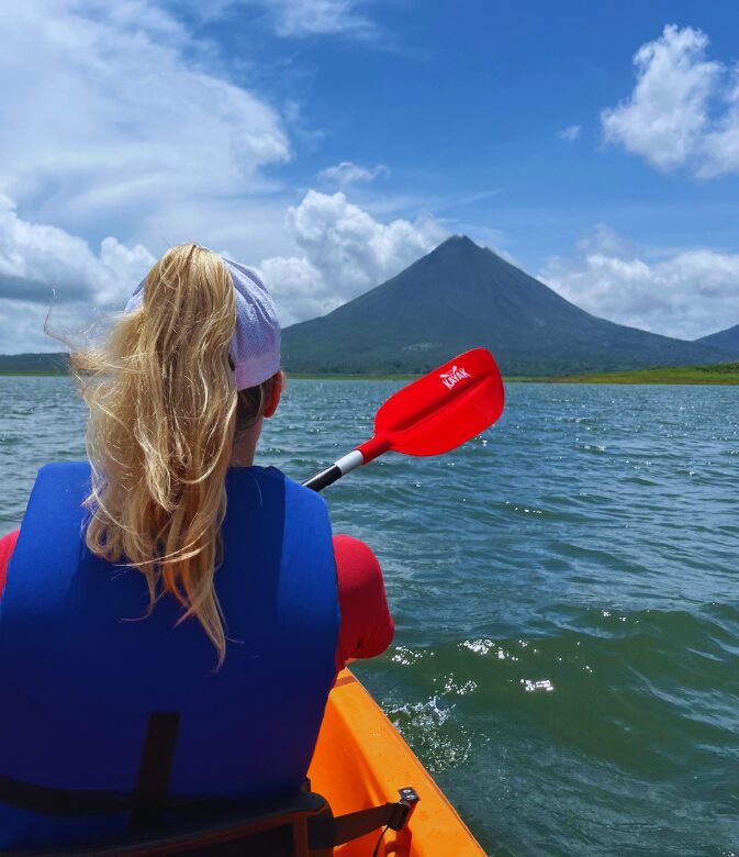 a girl in a kayak on lake arenal