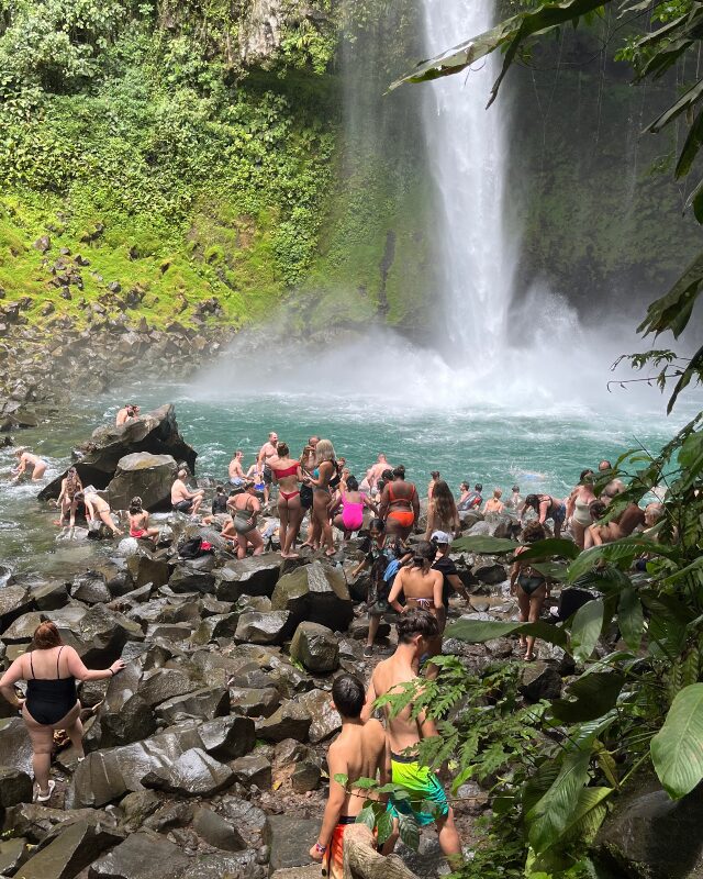 people swimming at la fortuna waterfall