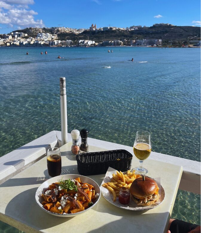 Beachfront dining at Munchies Restaurant, Mellieha Bay.