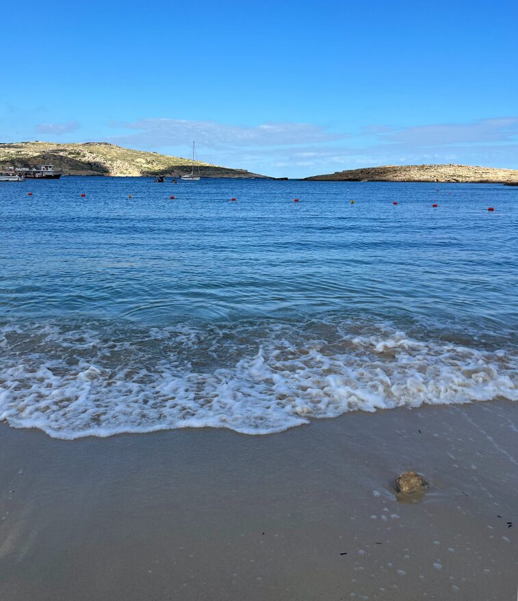 Santa Maria Bay on Comino with clear blue water and a sandy cove.